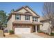 Charming two-story home with a brick and siding facade and a two-car garage at 2409 Brynfield Cv, Suwanee, GA 30024