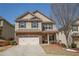 Charming two-story home featuring a brick and siding facade and a two-car garage at 2409 Brynfield Cv, Suwanee, GA 30024