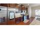 Gourmet kitchen features stainless steel appliances, granite countertops, and dark wood cabinetry at 2409 Brynfield Cv, Suwanee, GA 30024