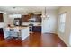 Modern kitchen with stainless steel appliances, hardwood floors, and a center island with bar seating at 2409 Brynfield Cv, Suwanee, GA 30024