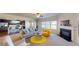 Open-concept living room with fireplace, large windows, and modern decor at 2409 Brynfield Cv, Suwanee, GA 30024