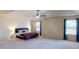 Large main bedroom with tray ceilings, cozy carpet, bedside lamps, and multiple large windows at 2409 Brynfield Cv, Suwanee, GA 30024