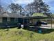 View of home's backyard with covered parking area, and outdoor space at 406 Dallas Hwy, Villa Rica, GA 30180