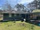 View of the home's backyard featuring a covered parking area and spacious yard at 406 Dallas Hwy, Villa Rica, GA 30180