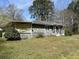 Exterior view of home showcasing a porch and foundation latticework at 406 Dallas Hwy, Villa Rica, GA 30180
