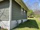 Exterior side of home with wooden siding, view of gas meter and foundation at 406 Dallas Hwy, Villa Rica, GA 30180