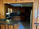 Kitchen with dark countertops, wood cabinets, black and white patterned flooring, and a vintage feel at 406 Dallas Hwy, Villa Rica, GA 30180