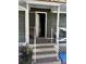 Exterior porch with concrete steps, peeling paint, and doorway into the home at 406 Dallas Hwy, Villa Rica, GA 30180