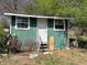Exterior of shed featuring wood paneling, white door and stairs at 406 Dallas Hwy, Villa Rica, GA 30180