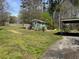 View of the yard and covered parking area of this single-Gathering home at 406 Dallas Hwy, Villa Rica, GA 30180