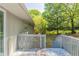 Back deck of the home with steps leading to the backyard and view of mature trees at 1477 Patricia Dr, Morrow, GA 30260