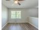 Bright bedroom featuring new floors, neutral paint, ceiling fan and a large window at 1477 Patricia Dr, Morrow, GA 30260