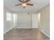 Nice bedroom featuring wood-look flooring, neutral walls, ceiling fan, and a sunny window at 1477 Patricia Dr, Morrow, GA 30260
