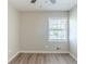 Clean bedroom featuring new floors, neutral paint, ceiling fan and a large window at 1477 Patricia Dr, Morrow, GA 30260