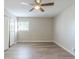 Clean bedroom featuring wood-look flooring, neutral walls, ceiling fan, and a window at 1477 Patricia Dr, Morrow, GA 30260