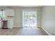 Dining area features a sliding glass door and updated floors at 1477 Patricia Dr, Morrow, GA 30260