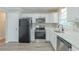 Modern kitchen featuring stainless steel appliances, quartz countertops, and white cabinets at 1477 Patricia Dr, Morrow, GA 30260