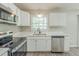 Stylish kitchen featuring stainless steel appliances, quartz countertops, and ample storage at 1477 Patricia Dr, Morrow, GA 30260