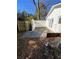 The backyard patio is made of concrete and surrounded by fences and the white exterior of the home at 1905 Robinhill Ct, Tucker, GA 30084