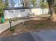 Charming single-story home with a white brick exterior, fenced yard, and well-manicured lawn at 1905 Robinhill Ct, Tucker, GA 30084