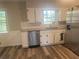 Well-lit kitchen with stainless steel appliances, white cabinets, and granite countertops at 1905 Robinhill Ct, Tucker, GA 30084