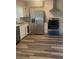 Modern kitchen featuring stainless steel refrigerator and stove, along with updated countertops at 1905 Robinhill Ct, Tucker, GA 30084