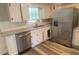 Bright kitchen with white cabinets, stainless steel appliances, and a granite countertop at 1905 Robinhill Ct, Tucker, GA 30084