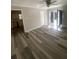Bright, light-filled room with french doors and modern flooring, seamlessly connecting to the kitchen at 1905 Robinhill Ct, Tucker, GA 30084