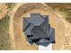 An aerial view captures the intricate roof design of a modern home, set against a natural backdrop at 4285 Haynes Cir, Snellville, GA 30039