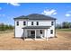 A modern white home with a covered patio and ample yard space is featured in the backyard at 4285 Haynes Cir, Snellville, GA 30039