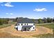 The backyard showcases a modern white home with a covered patio and ample yard space at 4285 Haynes Cir, Snellville, GA 30039