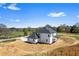 The backyard showcases a modern white home with a covered patio and ample yard space at 4285 Haynes Cir, Snellville, GA 30039