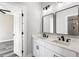 Bathroom featuring double sinks, framed mirrors, and modern black fixtures at 4285 Haynes Cir, Snellville, GA 30039