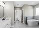 Bright bathroom with a soaking tub and a vanity with double sinks and modern fixtures at 4285 Haynes Cir, Snellville, GA 30039