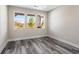 Neutral bedroom featuring bright windows with a pretty outdoor view and wood-look floors at 4285 Haynes Cir, Snellville, GA 30039