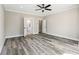 Large bedroom featuring wood-look floors, neutral paint, and doorway leading to an en suite bathroom at 4285 Haynes Cir, Snellville, GA 30039