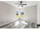 Bright bedroom featuring wood-look floors, a ceiling fan, and natural light from the windows at 4285 Haynes Cir, Snellville, GA 30039