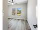 Bright bedroom featuring wood-look floors, a ceiling fan, and natural light from the windows at 4285 Haynes Cir, Snellville, GA 30039