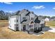 Well-manicured two-story home with a covered entryway, black framed windows and a two car garage at 4285 Haynes Cir, Snellville, GA 30039