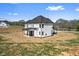 A modern white home with a covered patio and ample yard space is captured in the exterior view at 4285 Haynes Cir, Snellville, GA 30039