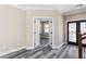 Bright foyer with wood-look floors, paneled doors, and decorative front door at 4285 Haynes Cir, Snellville, GA 30039