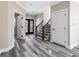 Bright foyer with wood-look floors, paneled doors, and staircase at 4285 Haynes Cir, Snellville, GA 30039