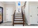 Inviting foyer featuring a staircase with wood treads, iron spindles, and plenty of natural light at 4285 Haynes Cir, Snellville, GA 30039