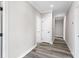 Hallway with neutral paint, wood flooring and doors at 4285 Haynes Cir, Snellville, GA 30039