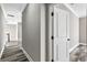 Hallway with wood-look floors and white trim, leading to rooms with ample natural light at 4285 Haynes Cir, Snellville, GA 30039