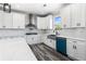 Bright kitchen featuring white cabinets, stylish backsplash, stainless steel hood, gas cooktop, and blue dishwasher at 4285 Haynes Cir, Snellville, GA 30039
