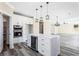 Modern kitchen features white cabinetry, stainless steel appliances, and a large center island with a wine cooler at 4285 Haynes Cir, Snellville, GA 30039