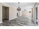 Spacious living room with modern lighting and ceiling fan with gray wood floors and lots of natural light at 4285 Haynes Cir, Snellville, GA 30039