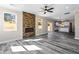 Living room with stone fireplace, wood-look floors and open view to the kitchen at 4285 Haynes Cir, Snellville, GA 30039