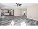 Bright, open-concept living room with wood-look floors and view to the kitchen at 4285 Haynes Cir, Snellville, GA 30039